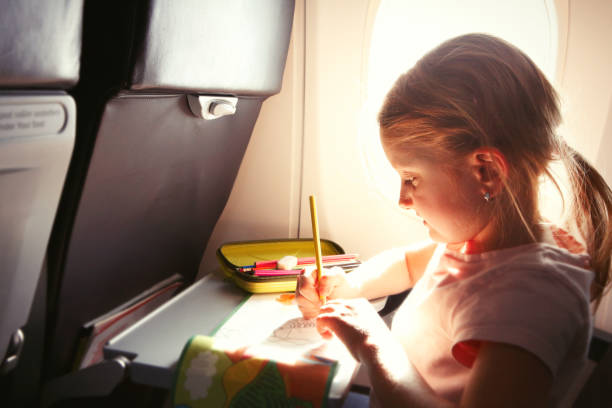 istock Little girl drawing a picture during flight 660605938