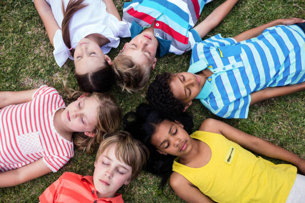 istock Children lying on grass with eyes closed 660606158