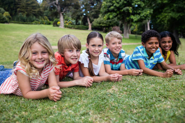 istock Happy children lying on grass 660606296