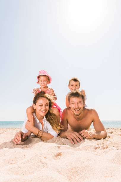 istock Happy family spending a summer day on the beach. 660606538