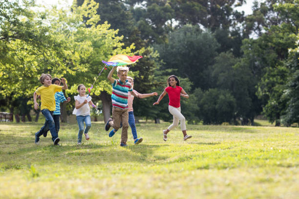 istock Happy children playing with a kite 660611168