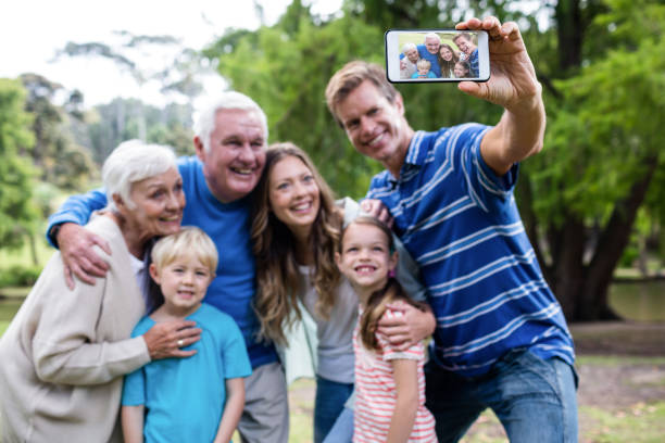 istock Multi-generation family taking a selfie in the park 660611340