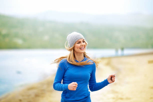 istock Blonde woman exercising on the beach 660611362