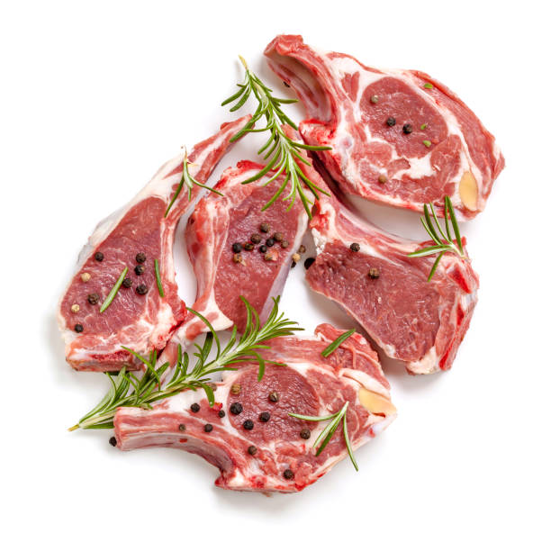 Raw Lamb Cutlets Top View Isolated with Rosemary and Peppercorns Raw lamb cutlets, top view, isolated, with rosemary and peppercorns. lamb meat photos stock pictures, royalty-free photos & images