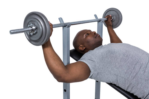 Fit man exercising with barbell on white background