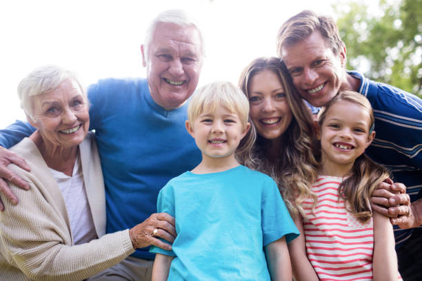 istock Multi-generation family standing in the park 660613508