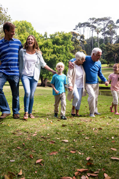 istock Multi-generation family walking in the park 660613704