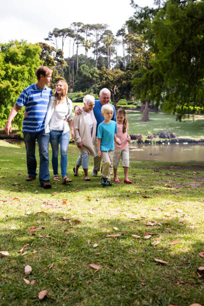 istock Multi-generation family walking in the park 660614110