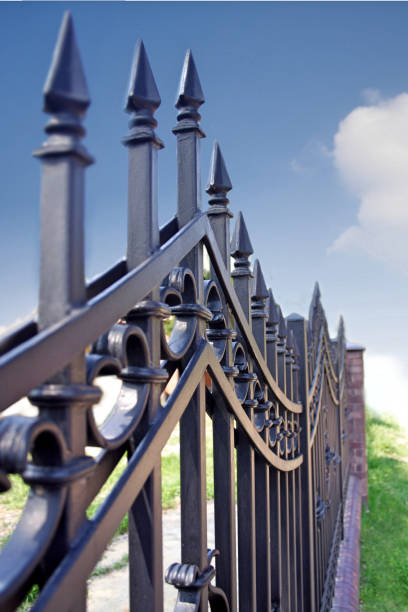 istock Metal fence over blue sky 660617888