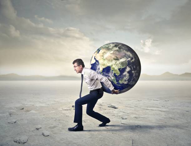 Working like Atlas Business man is holding the whole world on his back man holding earth stock pictures, royalty-free photos & images