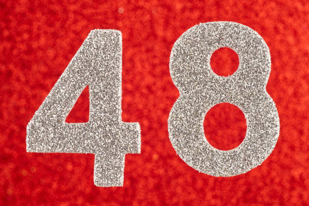 istock Number forty-eight silver color over a red background. Anniversary. 660621734