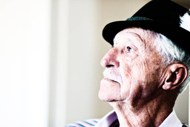 istock Very old man in Tyrolean hat looking serious in profile 660621878