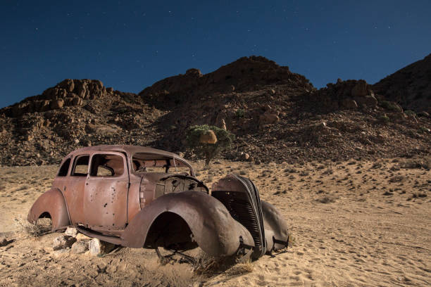 An abandon diamond smugglers car at midnight. An abandon diamond smugglers car at midnight. kolmanskop namibia stock pictures, royalty-free photos & images