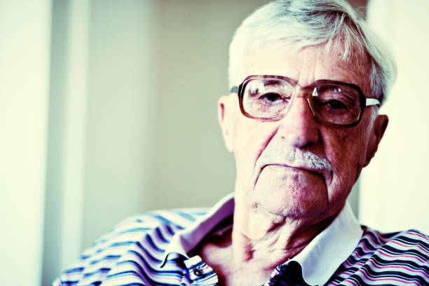 istock Senior man in horn-rimmed spectacles stares seriously at camera 660624664