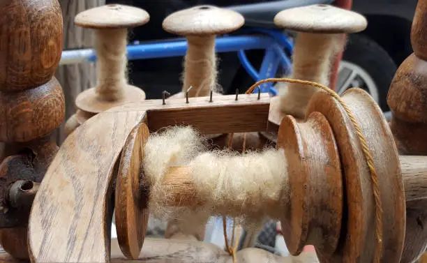 The bobbin on the spinning wheel close-up