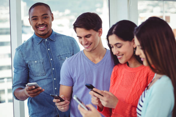 istock Young creative team looking at phones 660630316