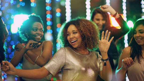 I'm always up for a party Shot of a group of young people having fun in a nightclub clubwear stock pictures, royalty-free photos & images