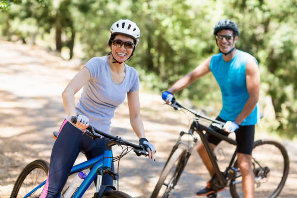 istock Couple smiling and posing with their bikes 660634410