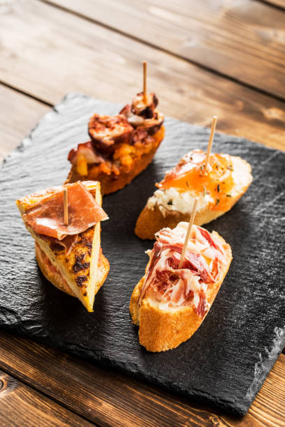 Spanish tapas Delicious spanish tapas  served on a wooden table. tortilla de patatas stock pictures, royalty-free photos & images