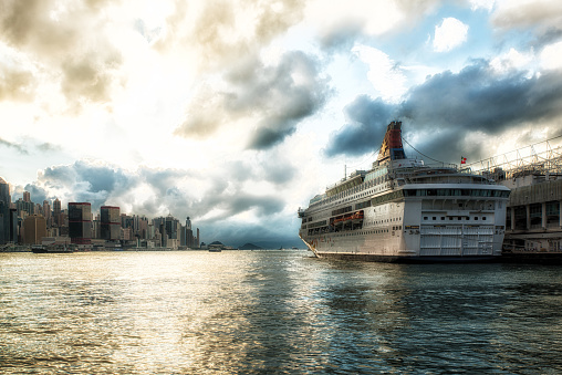 Cruise Ship at the Ocean Terminal on the Kowloon Peninsula, beautiful skyline of the HK Island with 2IFC in the backgrounds.
