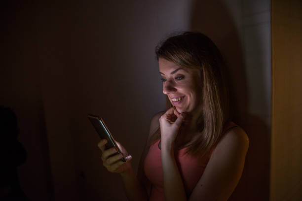 istock young woman looking at her mobile phone screen at night 660640188