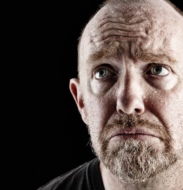 istock Mature, bearded man looks up, unhappy and concerned 660643996