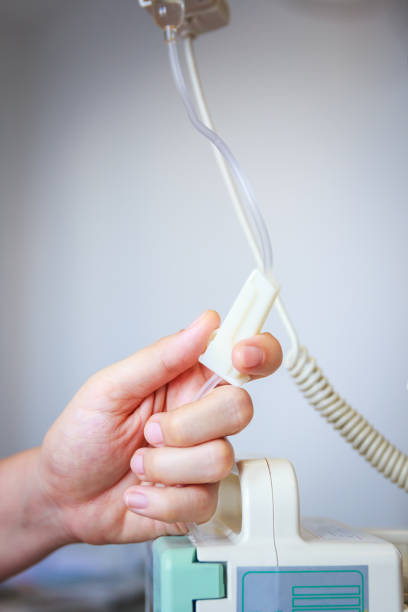 istock Nurse's hands regulation an intravenous (IV) drip in hospital room. 660648084