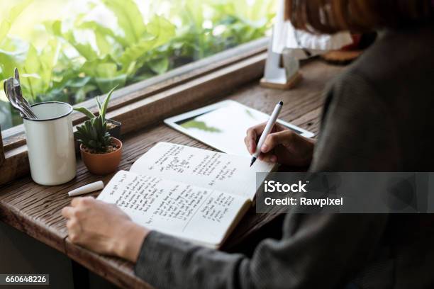 Girl With Glasses Sitting Wooden Table Workplace Stock Photo - Download Image Now - Writing - Activity, Diary, Handwriting