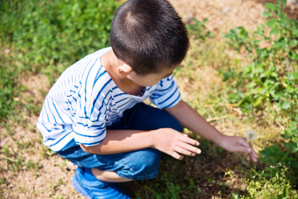 In Western Colorado Young Farm Boy Holding Frogs (Shot with Canon 5DS 50.6mp photos professionally retouched - Lightroom / Photoshop - original size 5792 x 8688 downsampled as needed for clarity and select focus used for dramatic effect)