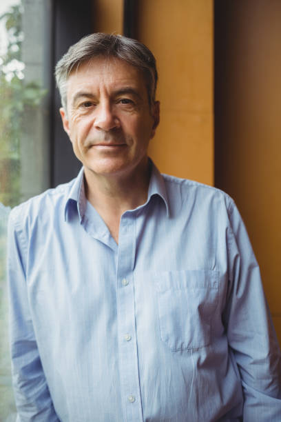 istock Portrait of professor standing near window 660655574