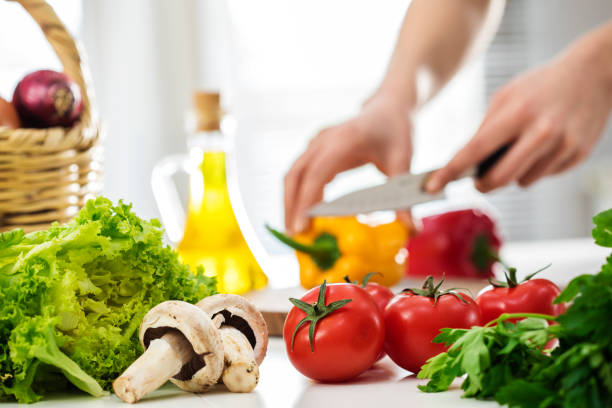 istock Woman hands cutting vegetables in the kitchen 660655632