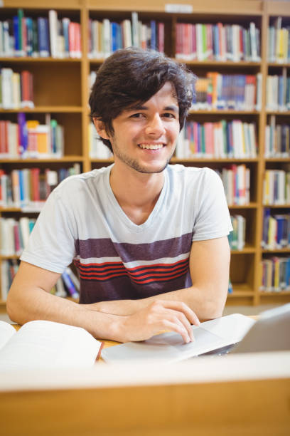 istock Portrait of happy young student using his laptop 660655990