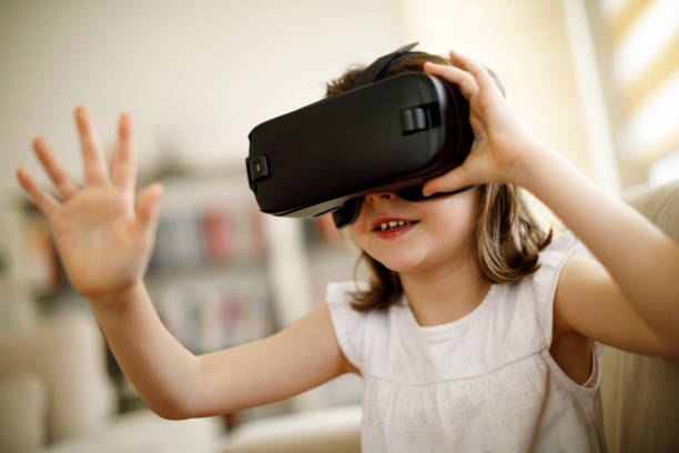 istock Little girl playing imaginary game with virtual reality headset 660656524