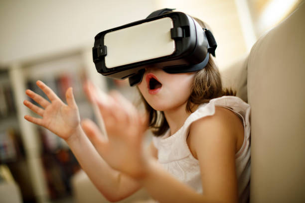istock Little girl playing imaginary game with virtual reality headset 660656888