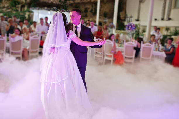 istock Awesome first wedding dance with smoke and rose purple lights. 660667100