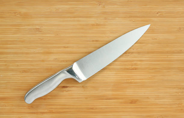 istock Steel kitchen knives on a wood board. 660670426