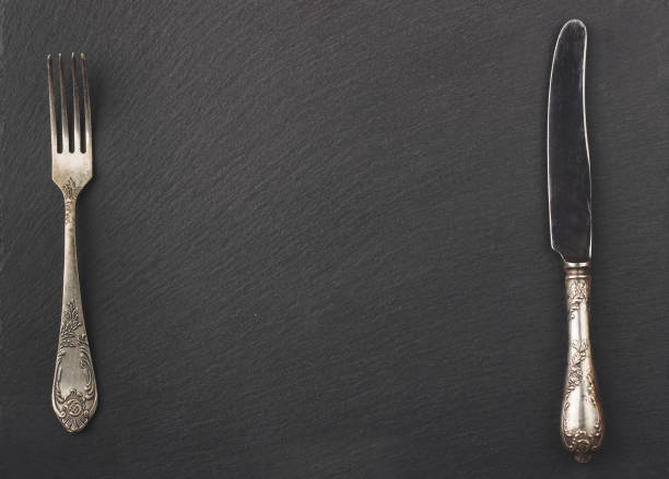 istock Melchior spoon and fork on the black stone background 660670522