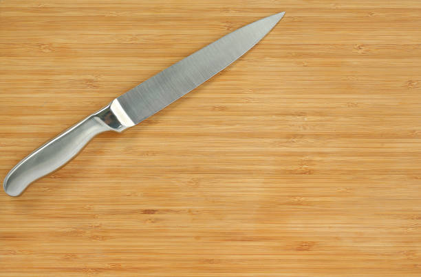 istock Steel kitchen knives on a wood board. 660670550