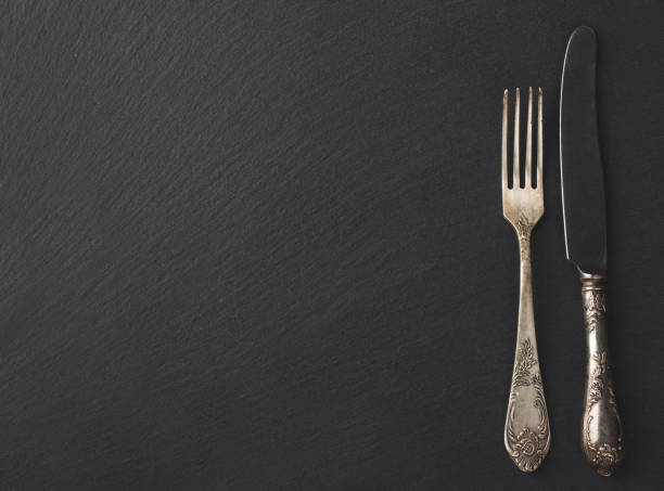 istock Melchior spoon and fork on the black stone background 660670790