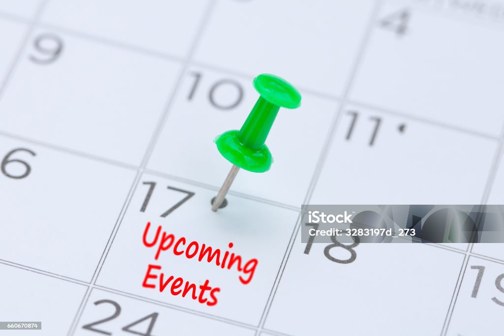Upcoming Events written on a calendar with a green push pin to remind you and important appointment. Event Stock Photo