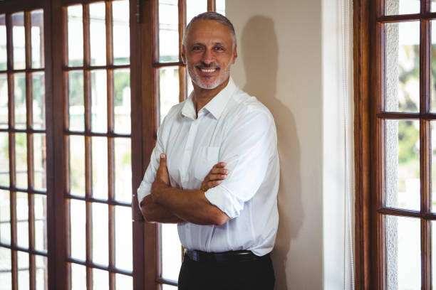 istock Smiling man with arms crossed 660673464