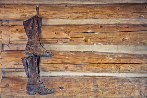 istock a pair of boots hanging from a wooden wall in a rustic cottage 660673930