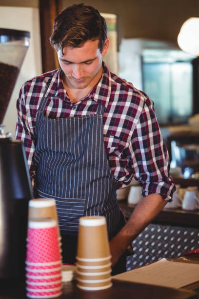 istock Waiter working at the till 660674218