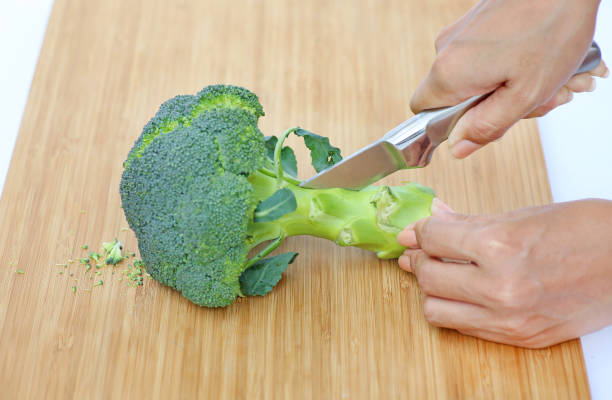 istock Woman cutting broccoli for cooking. 660677280