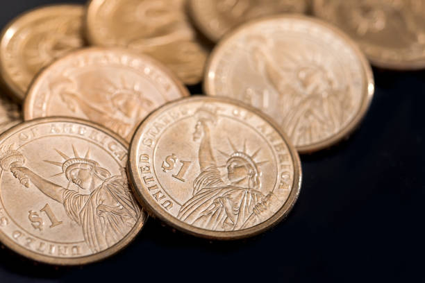 istock us coin dollar isolated on black background. 660677938