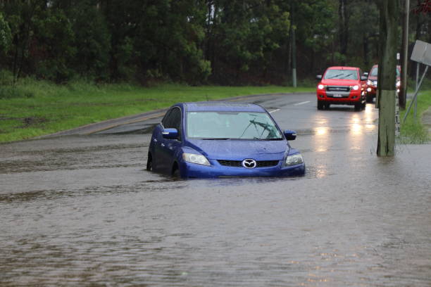 Vehicle stranded in floodwaters BRISBANE, AUSTRALIA - March 30, 2017: Car stuck in floodwater in the suburb of Rocklea from huge rainfall as a result of Tropical Cyclone Debbie. queensland floods stock pictures, royalty-free photos & images