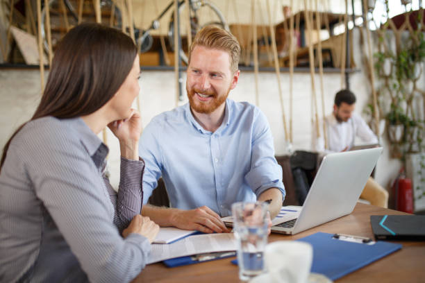 istock Two business people analyzing graphs at meeting in cafe. 660678688