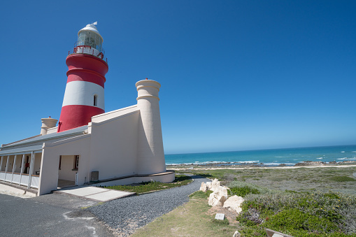 Cape Agulhas is a rocky headland in Western Cape, South Africa. It is the geographic southern tip of the African continent and the beginning of the dividing line between the Atlantic and Indian Ocean