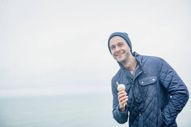 istock Happy man with ice cream, autumn day, Newquay, Cornwall. 660681364