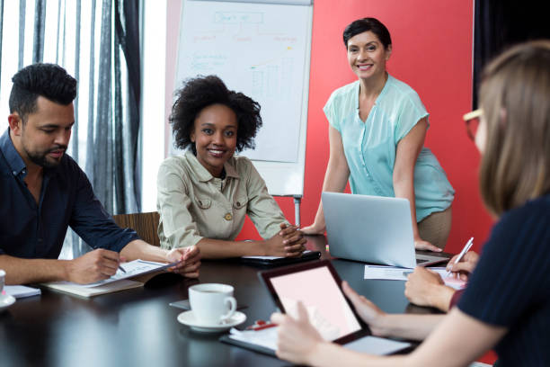 istock Business executives discussing over flip chart during meeting 660681478